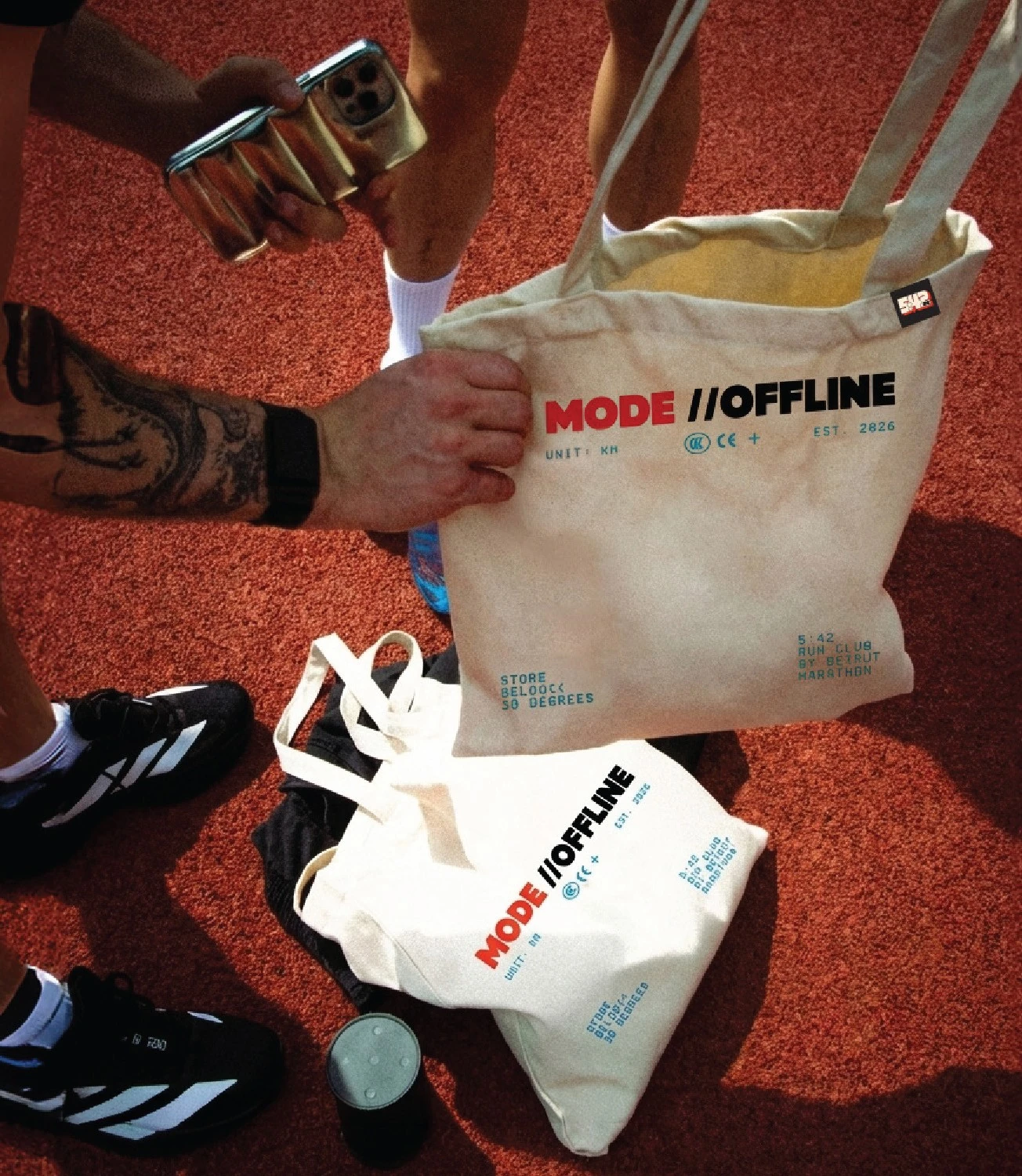 Runner holding a branded canvas tote and takeaway coffee cups