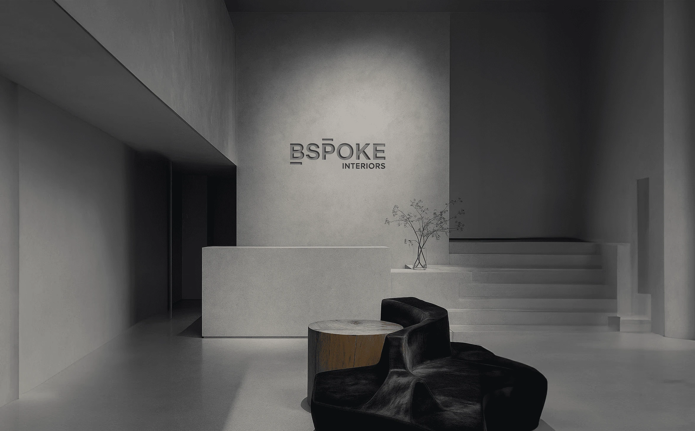 Bspoke Interiors wordmark on the wall of a minimal gray reception