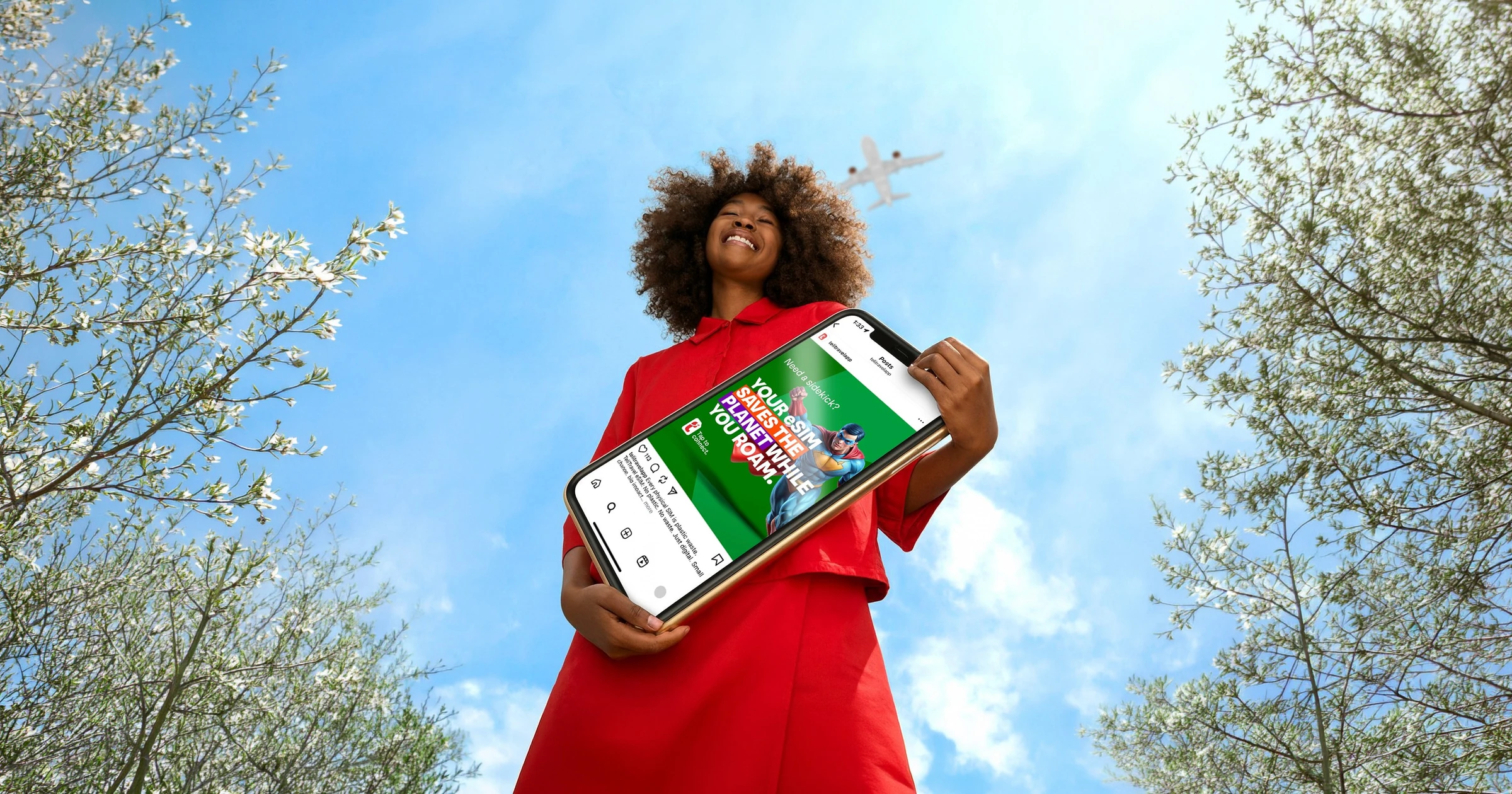 Telitravel campaign showing a traveler holding a tablet outdoors