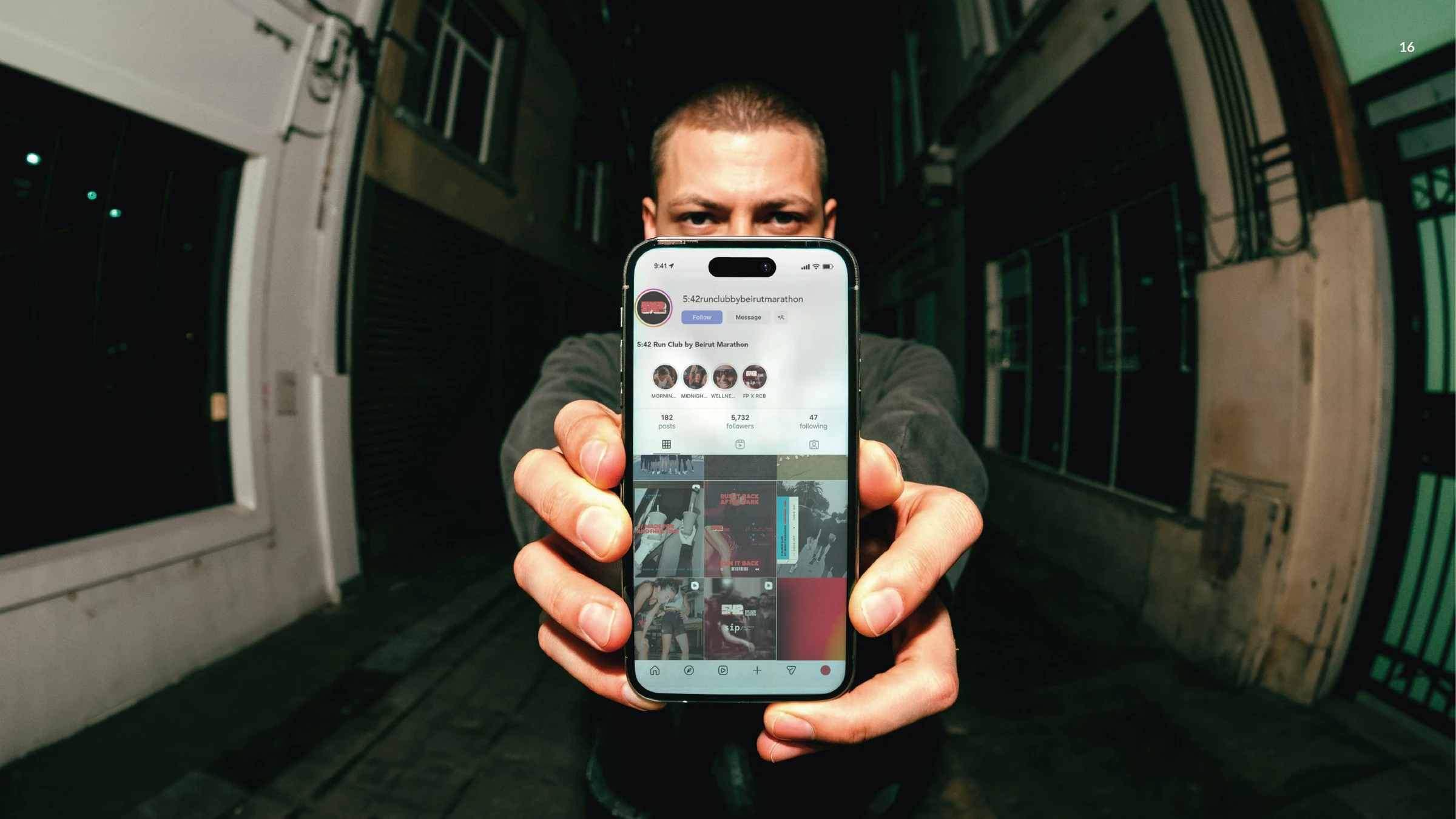 Runner holding a phone displaying the 5:42 Run Club social feed