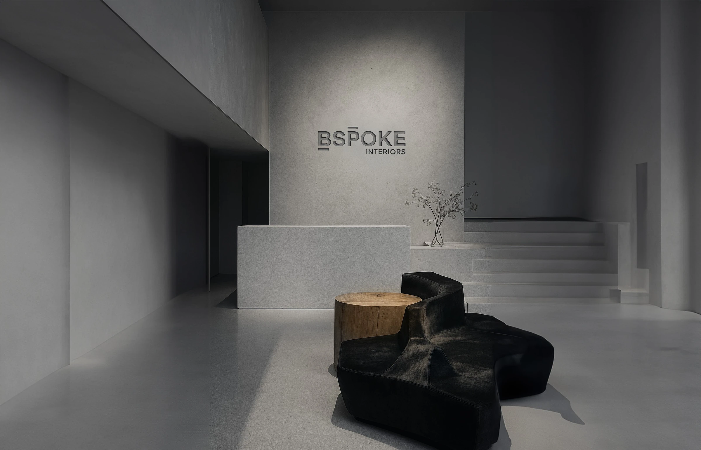 Minimal gray Bspoke Interiors reception with sculptural dark seating